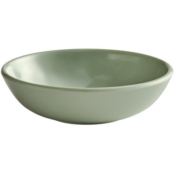 A close-up of a green Elite Global Solutions Hemlock melamine bowl.