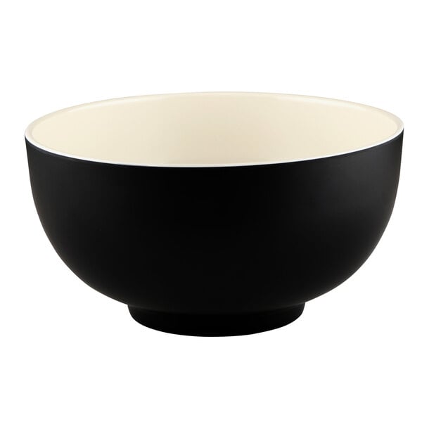 An Elite Global Solutions Karma melamine bowl with a black exterior and white interior and rim.
