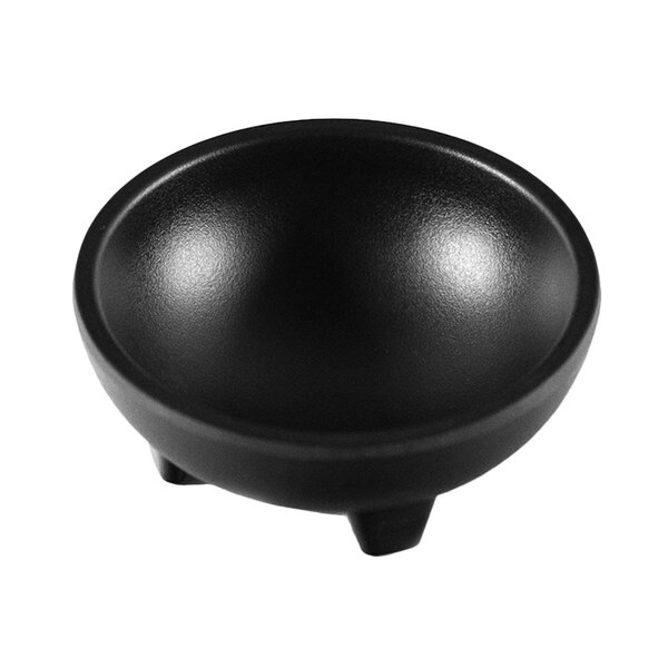 A black molcajete bowl with legs on a white background.
