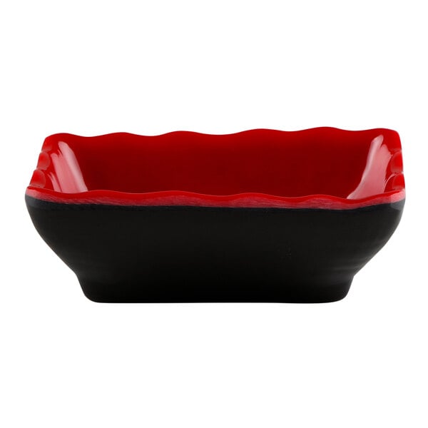 A black and red square Elite Global Solutions sauce dish with a black rim.