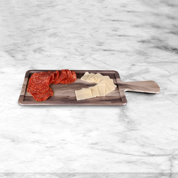 An Elite Global Solutions rectangular faux hickory wood serving board with cheese and salami on it.