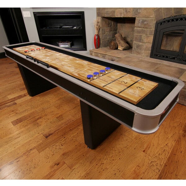 An Atomic shuffleboard table with blue chips on it.