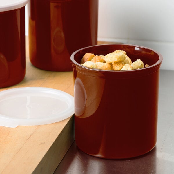 A red Cambro round polypropylene crock with food in it.