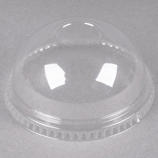 A Dart clear PET plastic dome lid on a clear plastic container.