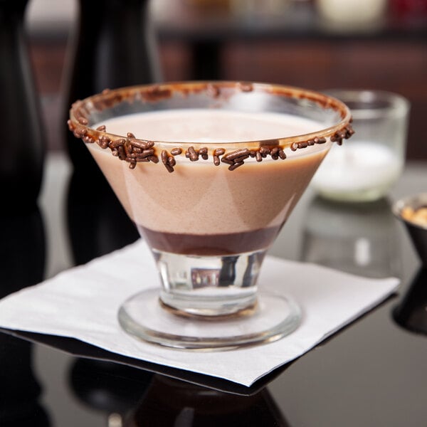 A Libbey mini martini glass filled with a layered dessert of chocolate and vanilla.