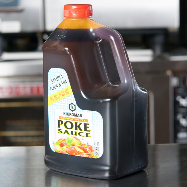 A plastic jug of Kikkoman poke sauce on a counter.