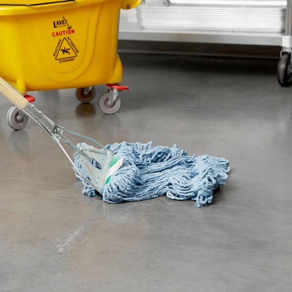 A Rubbermaid blue blend looped end wet mop in a yellow bucket with a handle.