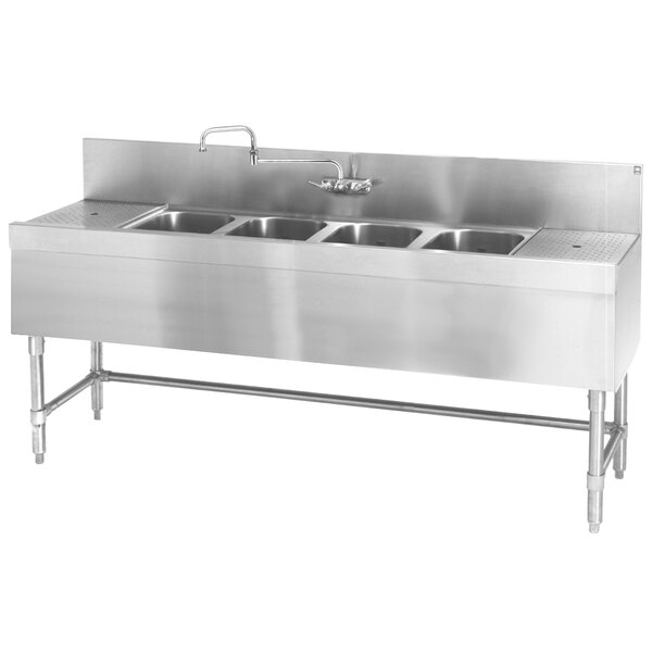 An Eagle Group stainless steel underbar sink with four bowls and drainboards.