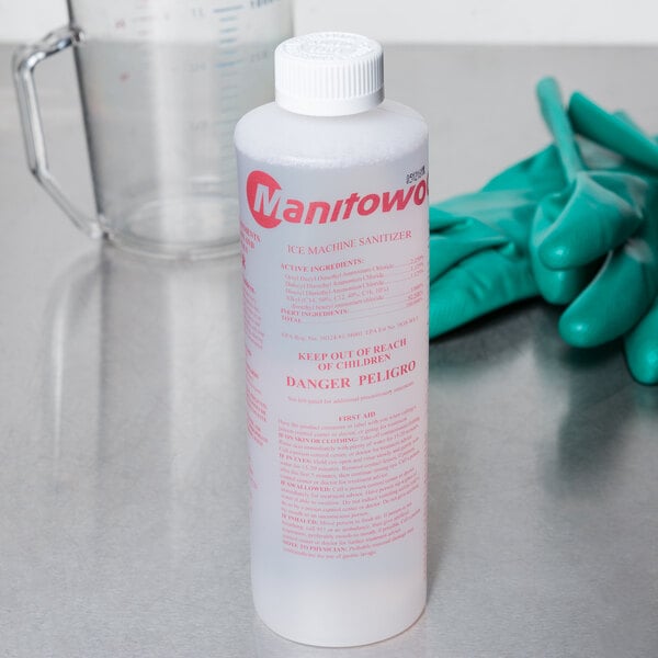 A white plastic bottle of Manitowoc Ice Machine Sanitizer with a red label.