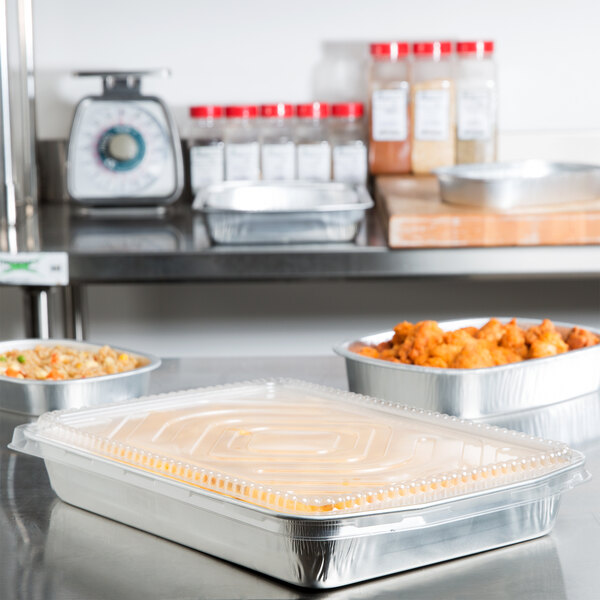 A silver Durable Packaging aluminum food container holding food.