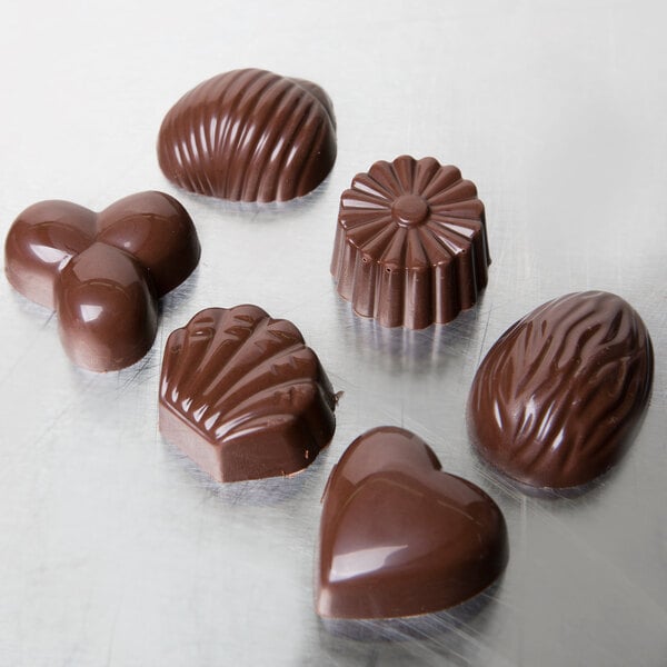 A Matfer Bourgeat chocolate mold with heart, flower, and shell shaped chocolates.