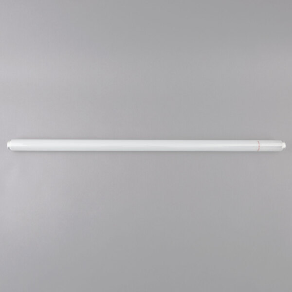 A Satco shatterproof white tube light bulb on a grey surface.