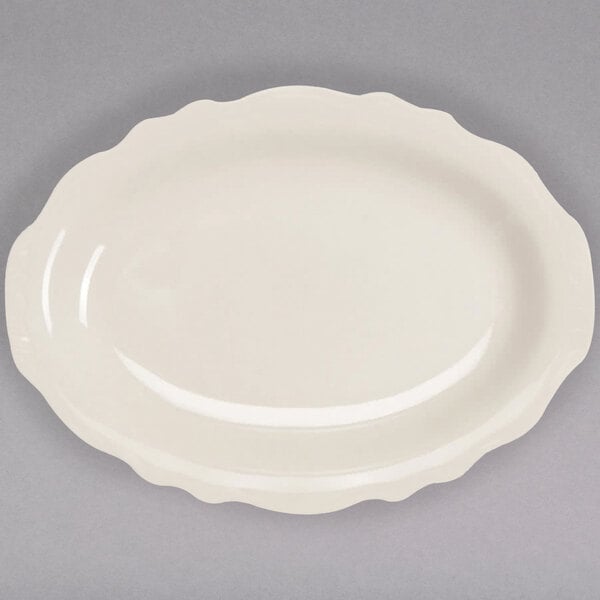 A white Homer Laughlin oval platter with scalloped edges.