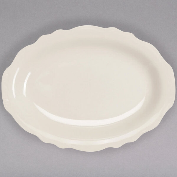 An ivory oval platter with a scalloped edge.