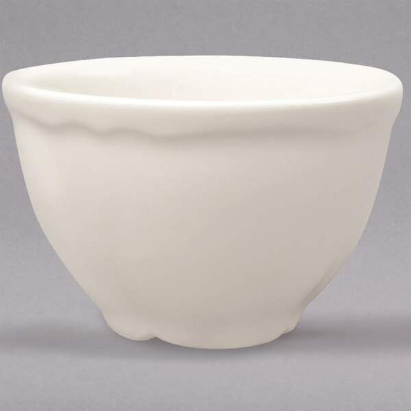 A white Homer Laughlin Carolyn bouillon bowl with a scalloped edge.