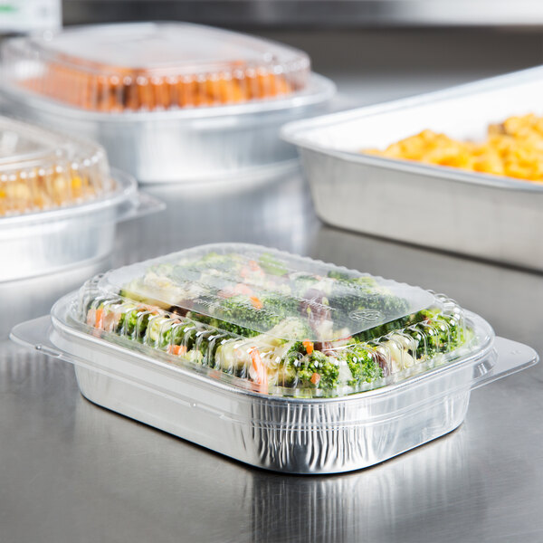 A Durable Packaging mini foil entree container with food on a table.