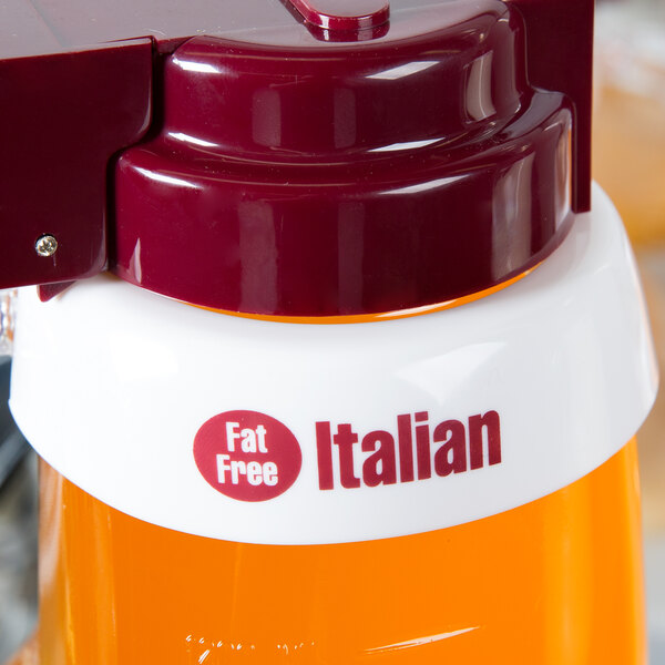 A close-up of a Tablecraft white plastic container with red and white lettering filled with orange liquid.