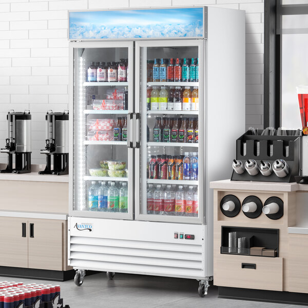 An Avantco white swing glass door merchandiser refrigerator with drinks and beverages.