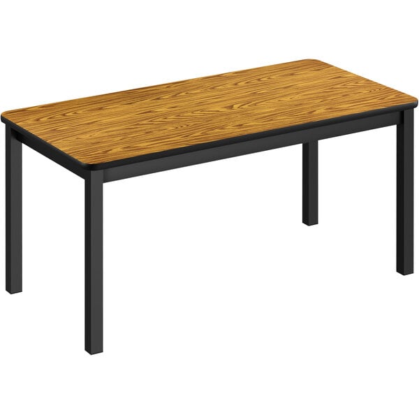 A Correll library table with a medium oak wooden top and black legs.