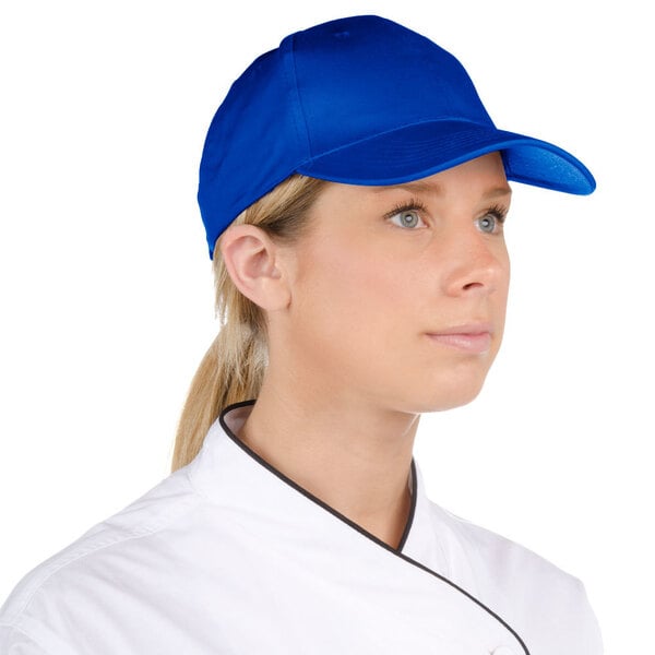 A chef wearing a royal blue 6-panel cap.