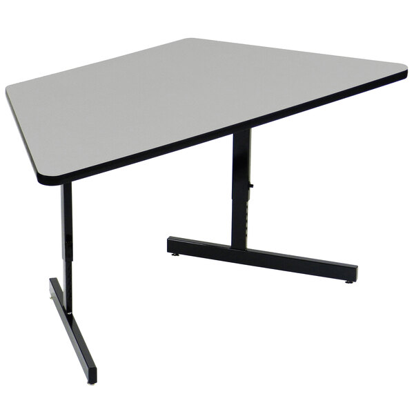 A grey trapezoid table with black legs.