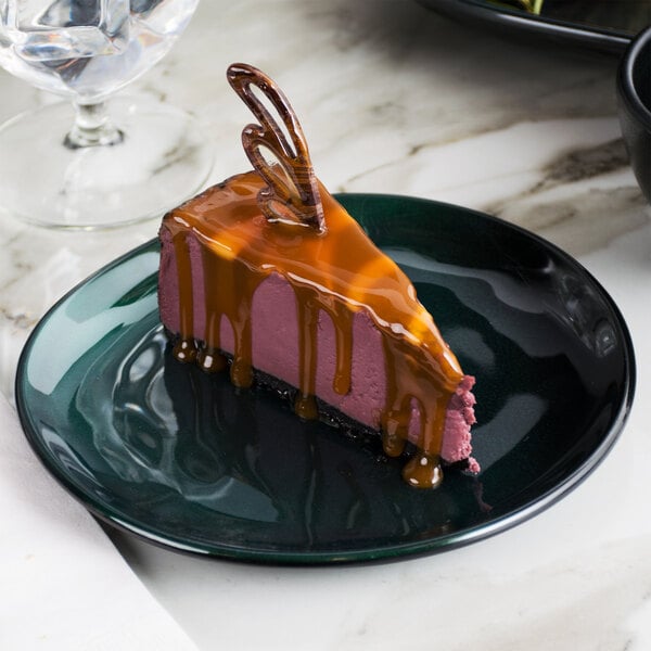 A piece of chocolate cake with caramel topping on a green GET Cosmo melamine plate.