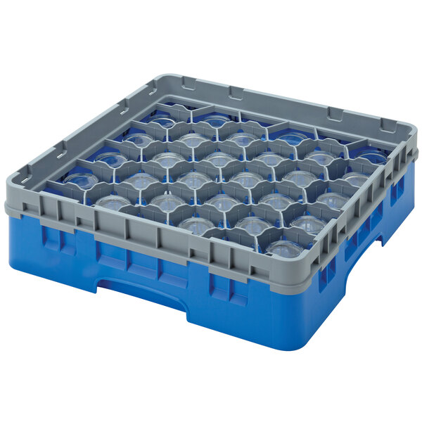 A blue and grey plastic Cambro glass rack with clear circles inside.
