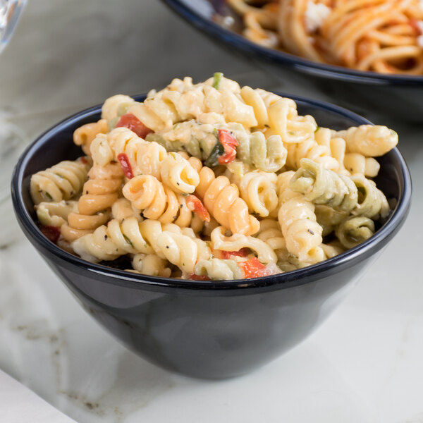 A blue Get Cosmo melamine bowl filled with pasta salad.