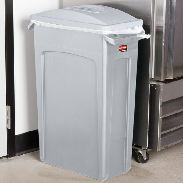 A Rubbermaid light grey plastic trash can with a lid.