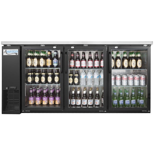 An Avantco black back bar refrigerator full of beer bottles.