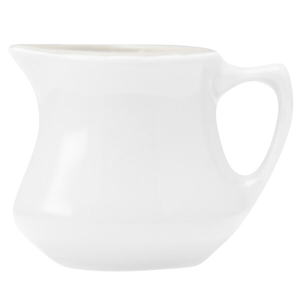 A Hall China bright white creamer with a handle.