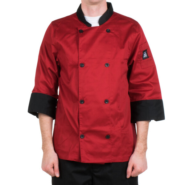 A man wearing a Chef Revival red chef jacket with black pants.