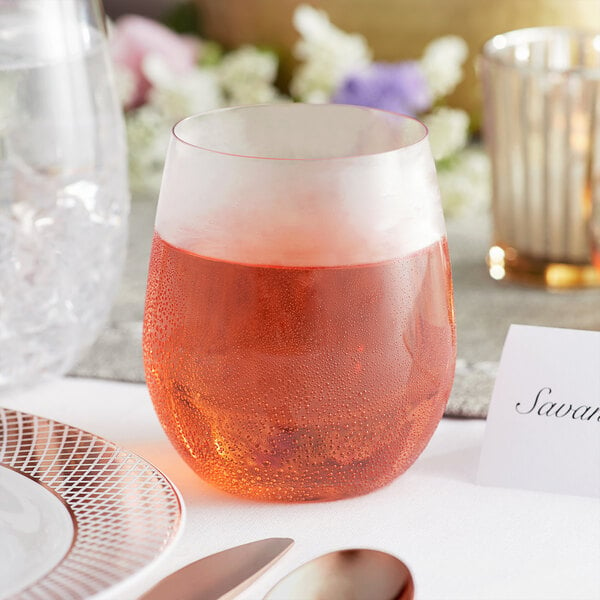 A Visions stemless wine glass filled with red wine on a table