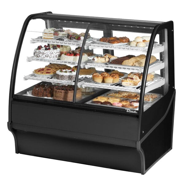 A True black dual service refrigerated bakery display case with various types of pastries.