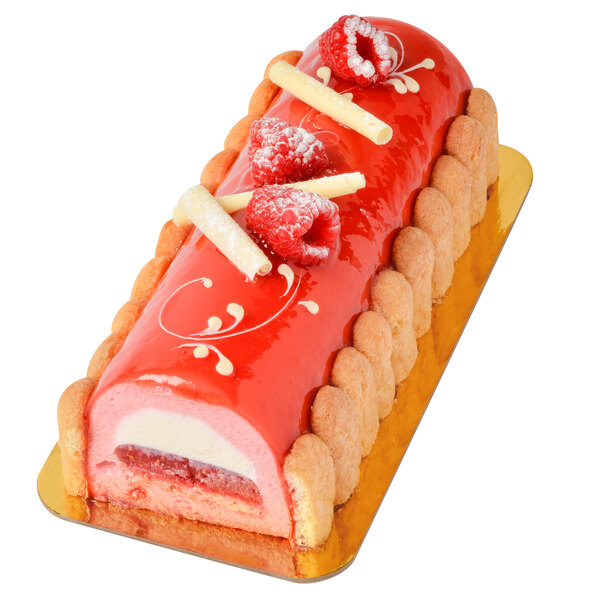 A round cake with red frosting and strawberries on top in an Ateco stainless steel terrine mold.