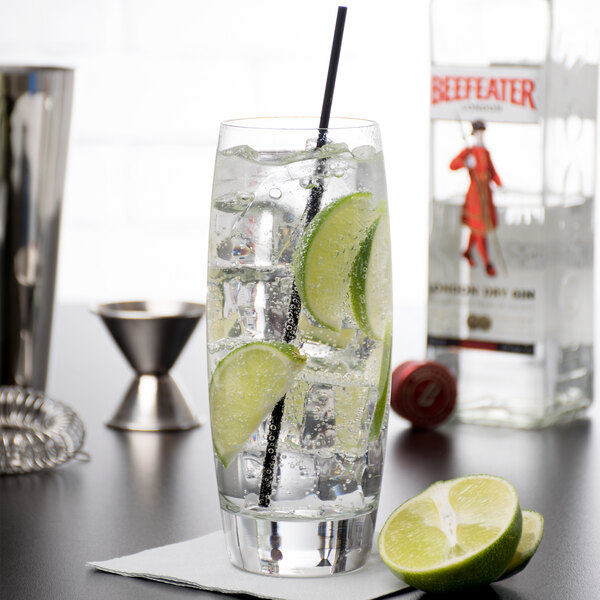 A Reserve by Libbey Symmetry cooler glass filled with water and lime slices on a table.