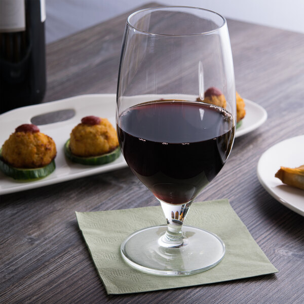 A Reserve by Libbey Neo goblet filled with red wine on a table with appetizers.