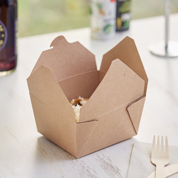 A brown Choice Kraft microwavable folded paper take-out box with food inside.