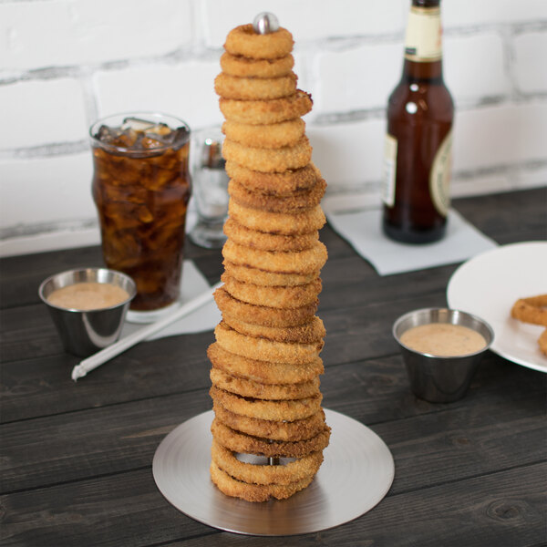 A Clipper Mill stainless steel tower holding a stack of fried onion rings.