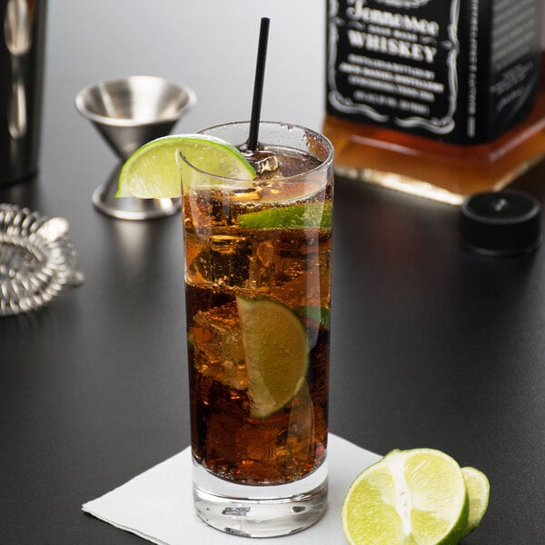 A Reserve by Libbey beverage glass filled with brown liquid and ice with a lime slice.