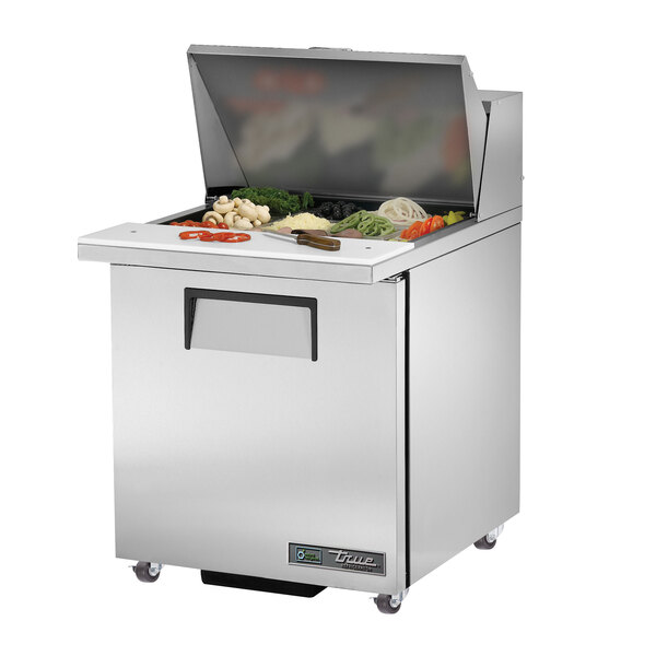A True stainless steel commercial sandwich prep table with food on top.