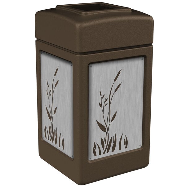 A brown rectangular Commercial Zone trash receptacle with stainless steel cattail designs.