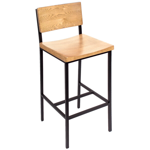 A BFM Seating Memphis bar height chair with a wooden seat and back on black metal legs.