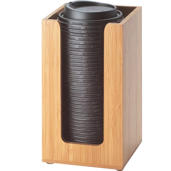 A bamboo Cal-Mil countertop cup and lid organizer holding black plastic cups.