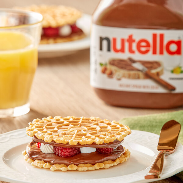 A waffle sandwich made with Nutella spread on a plate.