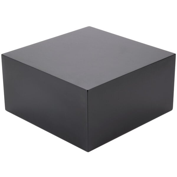 A black square cube riser.