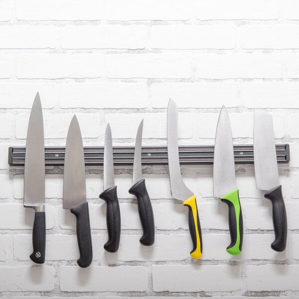 A group of knives on a Dexter-Russell magnetic knife strip.