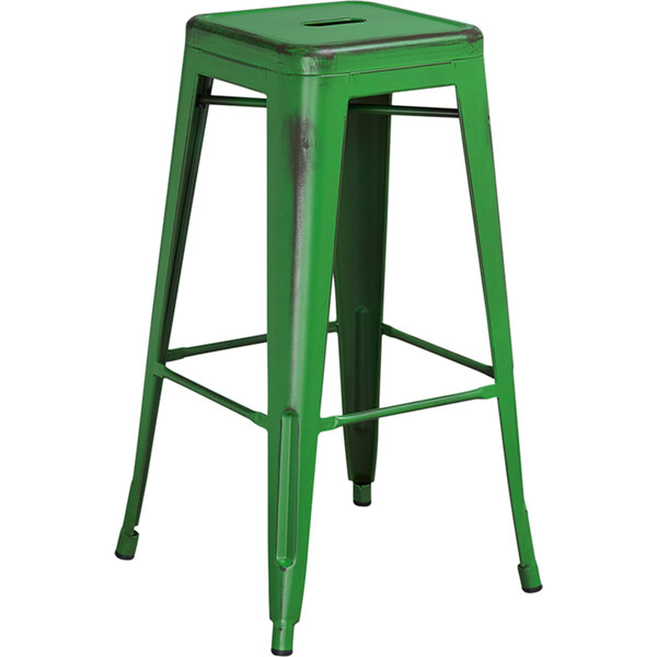 A green metal bar stool with a square seat.