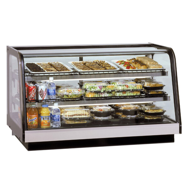 A Federal Industries countertop display case full of food on a counter.