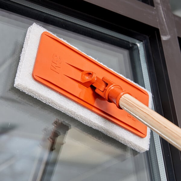 A 3M orange pad holder with a wooden handle.